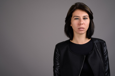 Young beautiful woman against gray backgroundの写真素材