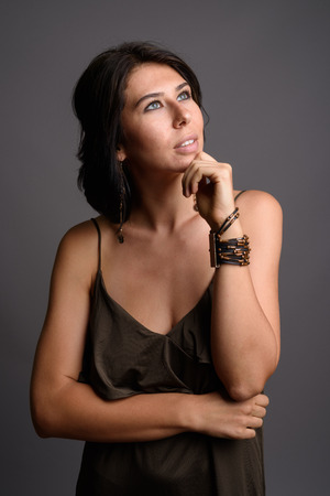 Young beautiful woman against gray backgroundの写真素材