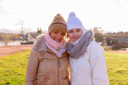 Two mature beautiful women together against scenic view of naturの写真素材