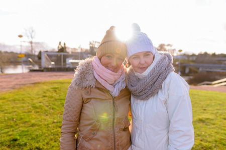 Two mature beautiful women together against scenic view of naturの写真素材