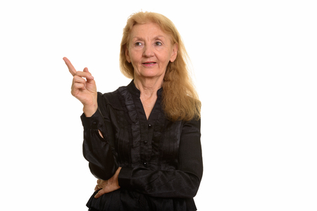 Studio shot of senior businesswoman pointing finger upの写真素材