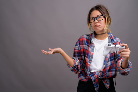 Young beautiful Kazakh woman against gray background