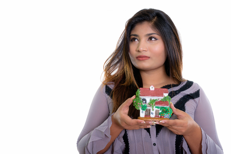 Close up of young fat Persian businesswoman thinking while holdiの写真素材