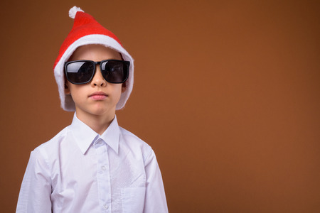 Young boy as businessman against brown backgroundの写真素材