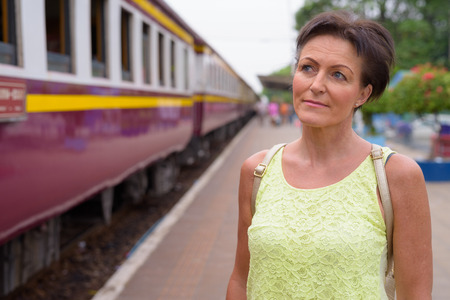 Mature beautiful Scandinavian tourist woman at railway station o