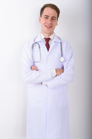 Young handsome man doctor against white backgroundの写真素材