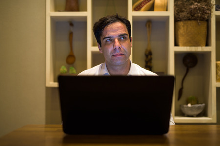 Man using laptop computer at home