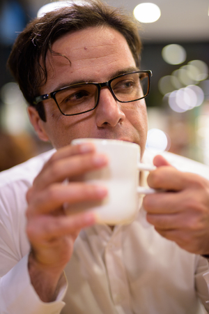 Man drinking coffee in coffee shopの写真素材