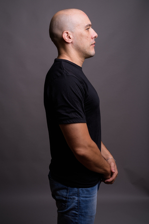 Handsome bald man against gray backgroundの写真素材