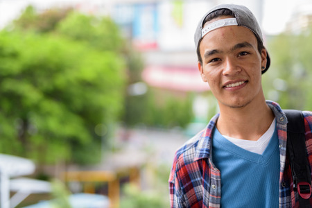 Young handsome Indian man exploring the city of Bangkok, Thailanの写真素材