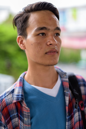 Young handsome Indian man exploring the city of Bangkok, Thailanの写真素材