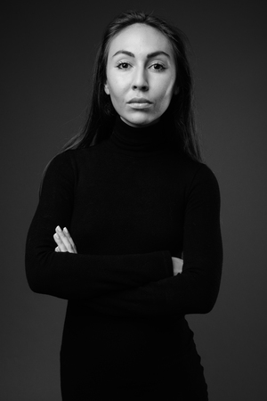Young beautiful businesswoman wearing long sleeved turtleneck drの写真素材