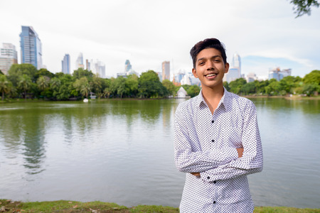 Portrait of young Indian teenage boy relaxing at the parkの写真素材