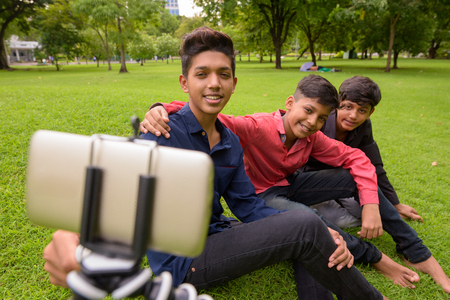Portrait of Indian family relaxing together at the parkの写真素材