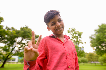 Portrait of young Indian boy relaxing at the parkの写真素材