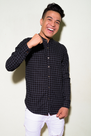 Young multi-ethnic man wearing smart clothing against white backgroundの写真素材