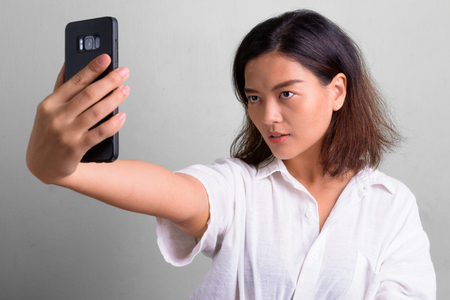 Portrait of young beautiful Asian woman with short hairの写真素材