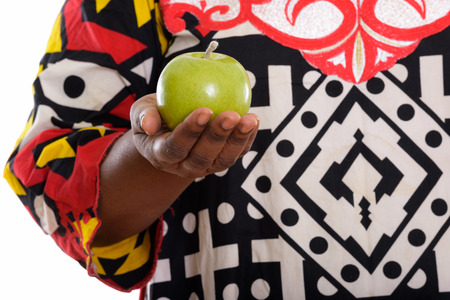 Studio shot of fat black African woman holding green appleの写真素材