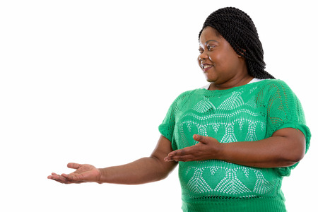 Profile view of happy fat black African woman smiling while showの写真素材