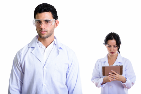 Studio shot of young man doctor wearing protective glasses and wの写真素材
