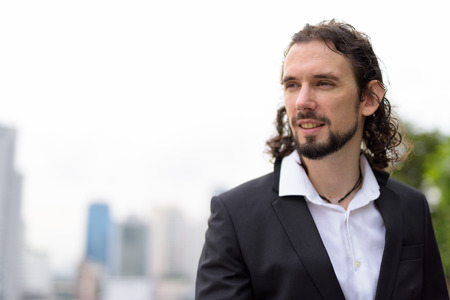 Handsome businessman against view of the city in Bangkok, Thaila
