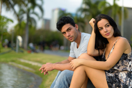 Young Hispanic couple relaxing in the park togetherの写真素材