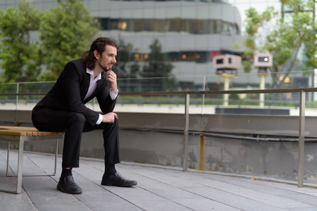 Handsome businessman against view of the city in Bangkok, Thailaの写真素材