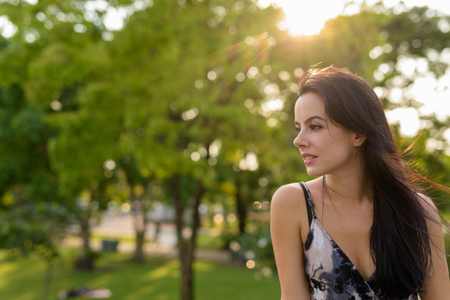 Young beautiful Hispanic woman relaxing in the parkの写真素材