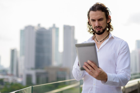 Handsome businessman against view of the city in Bangkok, Thailaの写真素材