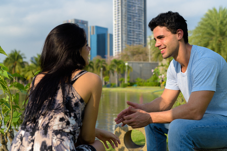 Young Hispanic couple relaxing in the park togetherの写真素材