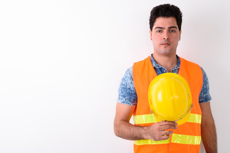 Young handsome Persian man construction worker against white bacの写真素材
