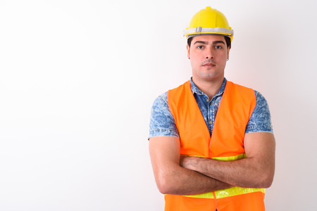 Young handsome Persian man construction worker against white bacの写真素材