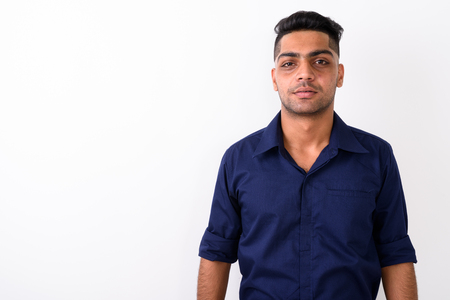 Studio shot of young Indian businessman against white backgroundの写真素材