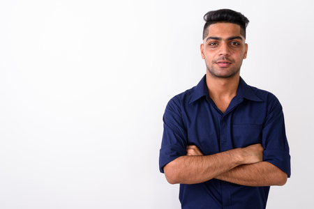 Studio shot of young Indian businessman against white backgroundの写真素材