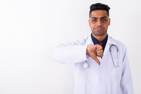 Young Indian man doctor against white backgroundの写真素材