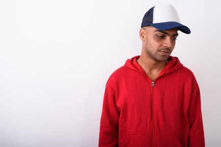 Young Indian man wearing hoodie against white backgroundの写真素材