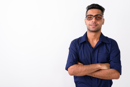 Young Indian businessman wearing eyeglasses against white backgrの写真素材