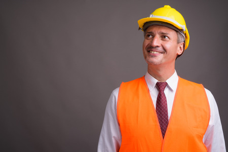 Portrait of man construction worker against gray backgroundの写真素材
