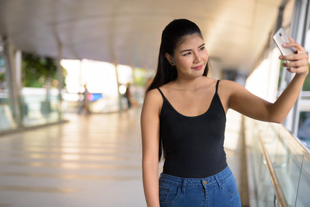Young beautiful Asian woman exploring around the cityの写真素材