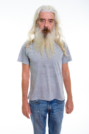 Studio shot of senior bearded man standingの写真素材