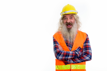 Studio shot of happy senior bearded man construction worker smilの写真素材