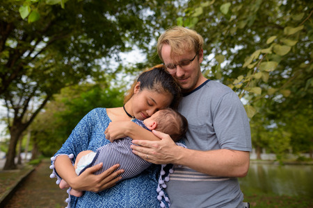 Multi-ethnic young family bonding together at the park