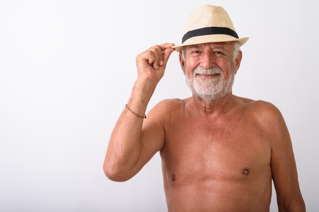 Happy senior bearded man smiling while wearing hatの写真素材