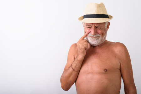 Studio shot of handsome senior bearded man thinking while lookinの写真素材