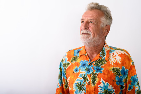 Close up of handsome senior bearded tourist man thinking againstの写真素材