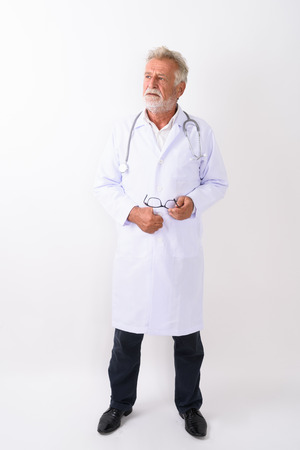 Full body shot of handsome senior bearded man doctor standing anの写真素材