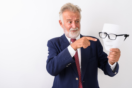 Studio shot of handsome senior bearded businessman looking and pの写真素材