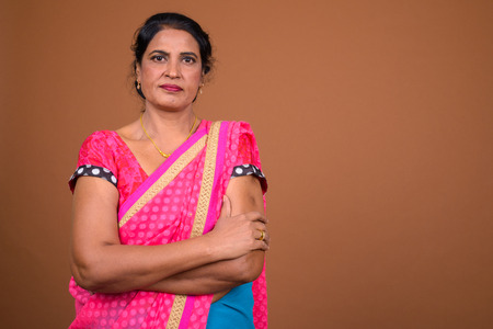 Mature beautiful Indian woman with arms crossedの写真素材