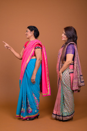 Full length profile view shot of two Indian woman standingの写真素材