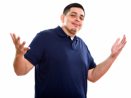 Studio shot of young Hispanic man with both arms raisedの写真素材